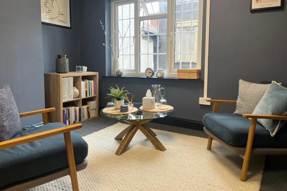 Counselling room in Altrincham with two chairs and coffee table – Jane Goodstone therapy practice